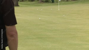 Chipping onto a golf practice green using aiming rods