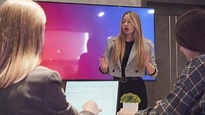 A young teacher gives a design lecture to young students who are passionate about their studies.