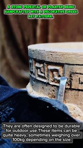 A stone pedestal or planter being handcrafted with a decorative Greek key pattern.