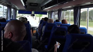 Inside the tourist bus. Point of view of the person who sits in the back seat.