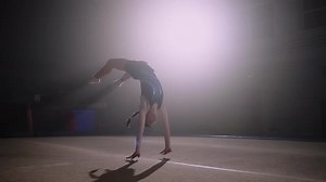 Preteen Girl is Doing Two Flips Back on Spring Floor Training of Artistic Gymnast in Gymnastics Hall