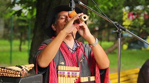 Man plays the Native American instruments