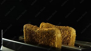 Golden roasted toast flying in slow motion from the toaster