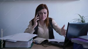 angry furious female office worker with a mental disorder screams from anger while talking on a telephone and throws paper due to a nervous breakdown at work, stress management
