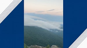 Time-lapse video shows clouds spilling over mountains