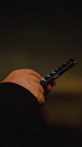 Download Man hand using smartphone technology, scrolling and browsing internet at home office. for free