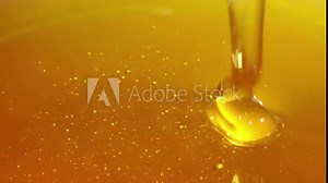 Pouring honey. Close-up of honey dripping.