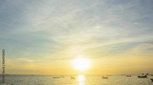 Sunset timelapse on the beach with cloudy sky background and sea and boat foreground. Nature and outdoor timelapse video clip