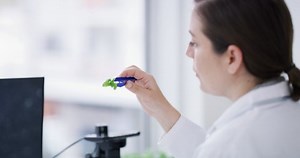 Science, microscope and plant research with computer screen for professional laboratory analysis. Leaf, employee and biotechnology scientist woman working with monitor for test and evaluation.