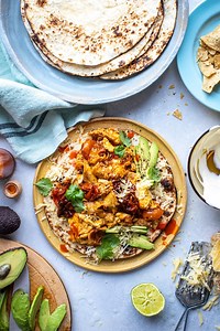 Typically a Mexican or Tex-Mex breakfast dish this also makes a cracking supper. Feel free to experiment with what you add to your eggs: chorizo, black beans or pickled jalapeños go down a treat. Serves: 4 Ingredients (US & METRIC): 4 large flour tortillas 2 tbsp olive oil 1 small onion, sliced 2 garlic cloves, sliced 2 tbsp chipotle chilli paste 350g (12oz) cherry tomatoes or vine tomatoes 2 large handfuls of corn tortilla chips, roughly crushed 8 medium free-range eggs, beaten 75g (⅔ cup) Ched