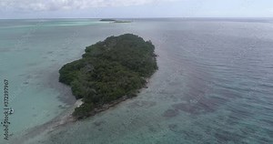Landscape Maseta Cote island with boat, divers, blue water, Green mangrove in Los Roques National Park Venezuela Caribbean Sea. Aerial view drone 4k