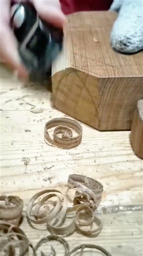 smoothing wood surface using hand plane removing thin shavings while guiding tool evenly