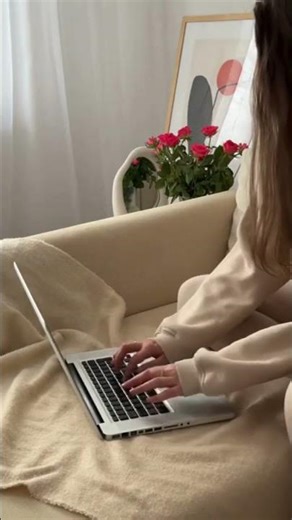 Woman Typing on Laptop in Cozy Home Setting
