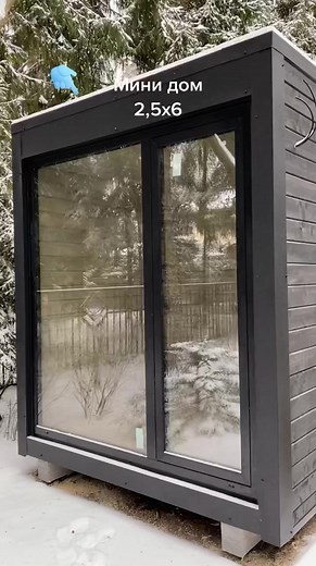 Modern Black Wooden Cabin in Snowy Forest