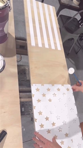 🇺🇸patriotic porch signs for summer🇺🇸 This tall sign is made from 3/4” thick plywood that’s cut down to 48”x12! I’m using masking tape to create the striped pattern. That little piece of tape in the middle just helps me evenly space the stripes. For the star side, I’m using a stencil of course. Make sure you use a LIGHT coat of paint so it doesn’t bleed. After I let this paint dry I’ll sand over it & then use some minwax stain to darken the wood color. The stain wipes away really easily from 