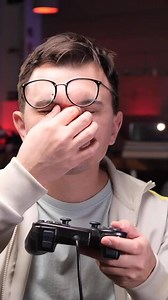 vertical Gamer feeling tired and rubbing eyes while playing videogames at home