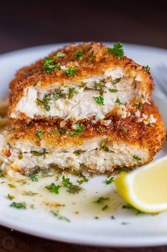 Chicken Kiev is making a comeback! This irresistible garlic butter-stuffed chicken breast is breaded and pan-fried. RECIPE: https://natashaskitchen.com/easy-chicken-kiev-recipe/ | NatashasKitchen.com