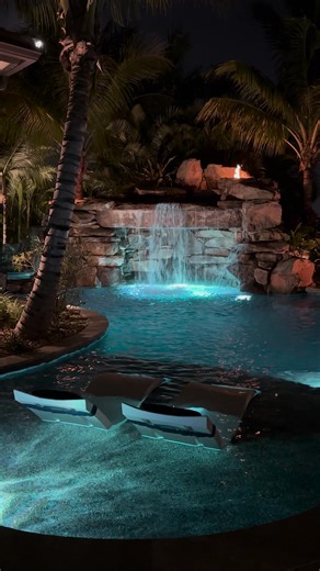 This South Florida Insane Pool shines bright at night. We create a jaw-dropping environment of recreation and relaxation that is 100% customized and unique to every client! #insanepools #lucaslagoons #poolbuilder #pool #backyard | Lucas Lagoons Design