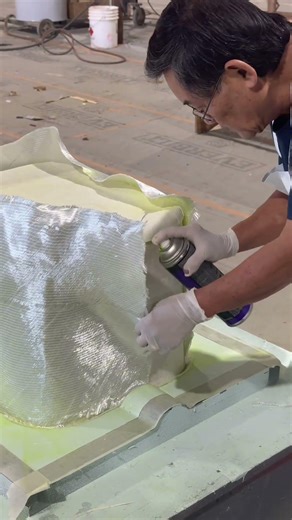 Carefully layering fiberglass #NuWaveComposites #VacuumInfusion #DryLayup