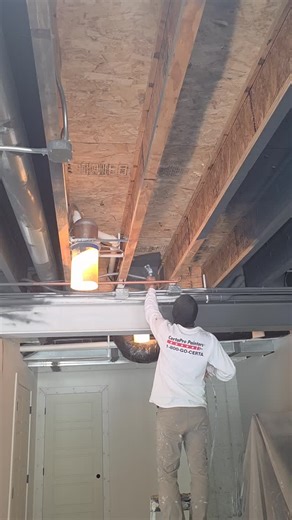 Sherwin-Williams Dryfall is the perfect solution for transforming an open, exposed ceiling into a sleek industrial vibe — especially in a rec room or entertainment space. 🎨✨ It sprays on smoothly for clean, uniform coverage and the overspray dries to a fine powder before it hits the floor, making clean-up a breeze. If you love that modern, loft-style look with ducts and joists on display, Dryfall helps tie it all together with a professional finish. 🔥 Industrial ceilings never looked so good. 