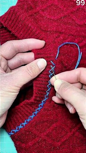 Blue thread crisscross stitching red knit fabric