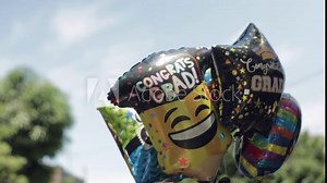Graduation Balloons Float in the Air for Celebration, Slow Motion, Blue Sky Stock Video