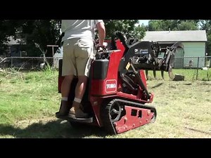 Cleaning up a dead tree with a Toro Dingo TX 1000 using a Grapple Rake