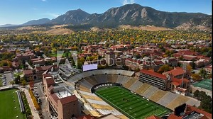 Aerial Reverse over Folsom Field Football stadium in Boulder, Colorado at the University of Colorado on a clear fall day
