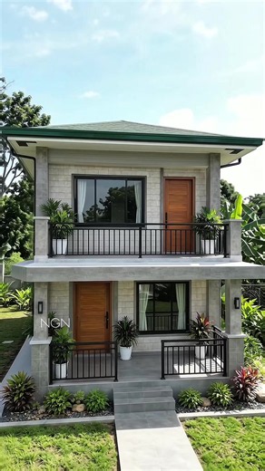 🇵🇭 MODERN TROPICAL TWO-STOREY HOME 🖤💚 #99 📐 Estimated Floor Area: 100–120 SQM 🛏️ Estimated Bedrooms: 3 Bedrooms 🛁 Estimated Bathrooms: 2 Bathrooms ✨ Design Features: • Two-storey modern Filipino home • Spacious upper-floor balcony with black steel railing • Covered ground-floor porch with matching railing • Gray concrete rain protection/eaves • Textured light-gray exterior walls • Natural wood-finish doors • Black aluminum-framed glass windows • Green long-span metal roof • Gray tiled por