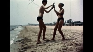 clip-3413982799-funny-young-couple-having-fun-on-sea