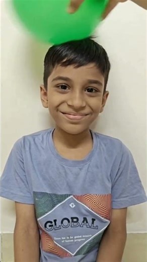 Why do hair stand up when a balloon is rubbed on them