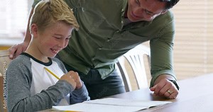 Father, kid with homework and help with math home education for child development, learning motivation and writing pencil in notebook. Happy, proud dad teaching and homeschool studying in family home