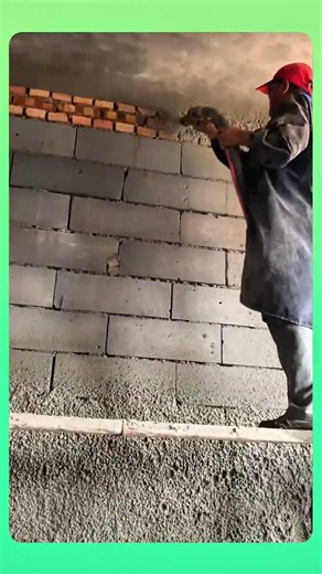 Wall plastering technique by spraying cement mix evenly for a smooth, solid finish. #Plastering #DIY