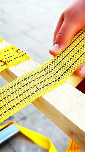 Stapled strap secured—testing strength across wood and steel.