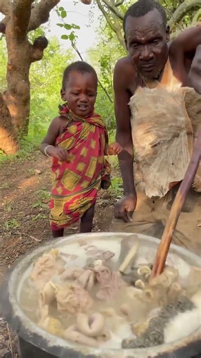 Traditional Hadzabe tribe cooking wild meat in Tanzania.Village food and African culture lifestyle.