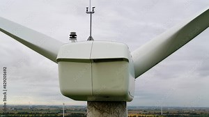 Wind Turbine Nacelle from Behind Using an Aerial Drone for Inspection, Close Up Shot Panning Around.