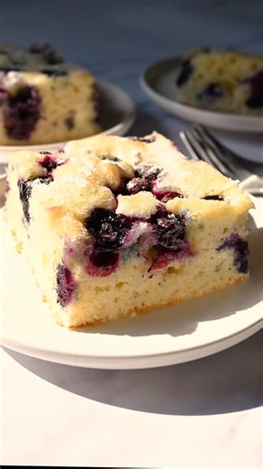 How to Make @mollyallenmedia’s Easy Blueberry Sheet Cake Ingredients Nonstick cooking spray 1 1/4 cups fresh or frozen blueberries 2 cups (240g) plus 1 tablespoon all-purpose flour, divided 1 1/4 cups (250g) plus 2 tablespoons granulated sugar, divided 1/2 teaspoon baking powder 1/2 teaspoon baking soda 1/2 teaspoon salt 2 large eggs, at room temperature 1 cup milk, 2% preferred 1/2 cup canola oil Finely grated zest of 1 medium lemon Method Preheat the oven to 350°F. Line a 9x13-inch baking pan 