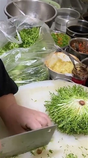 cutting a vegetable into several pieces using a knife which will be processed immediately