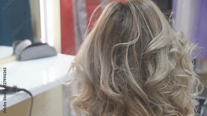 Stylish by professionals you can trust. hairdresser doing her clients hair with a hair drier on the background of the hairdressing salon