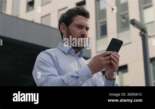 Mad unhappy European middle aged businessman using smartphone in city angry male employer annoyed frustrated by bad signal spam message irritated mature business man outdoor work mobile phone daylight Stock Video Footage - Alamy
