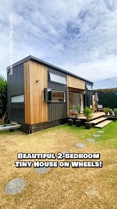 Would you live in this 300-sqft tiny house on wheels? Definitely one of my favorite tiny houses I've ever seen! Inside, this tiny home features 2 standing-height private bedrooms, a spacious living area with a sectional couch, a large U-shaped kitchen with tons of storage, & a full bathroom with a tile shower & a washer/dryer unit! Built by shayes_tiny_homes in New Zealand—please reach out to their team for updated pricing! #tinyhouse #tinyhome #housetour #hometour #ADU | Dream Big Live Tiny Co.