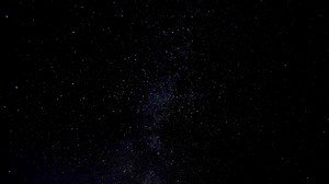 Timelapse of moving stars in night sky. Stars move around a polar star.