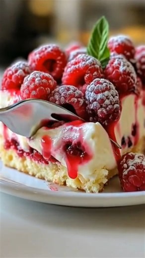 White Chocolate Raspberry Poke Cake 🤍🍰🍓 The kind of dessert that brings people back to the kitchen Ingredients: - 1 box white cake mix - Ingredients required on cake mix box (eggs, oil, water) - 1 cup raspberry preserves or raspberry pie filling - 1 can sweetened condensed milk (14 oz) - 1 cup white chocolate chips - 1/2 cup heavy cream - 8 oz whipped topping, thawed - Fresh raspberries for garnish (optional) - White chocolate shavings for garnish (optional) Directions: 1. Preheat the oven ac