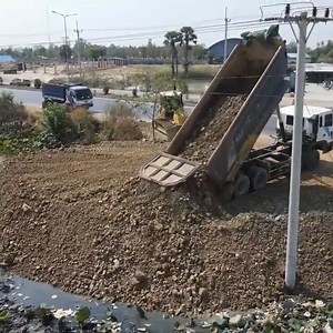 Land Filling Process operator by DR 51PX Bulldozer Dump Truck Spreading Rock Source : Mr Machines at YouTube channel | Alat Berat Mania
