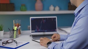 Successful Adult Cheers Stock Market Success at Desk