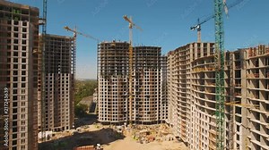 Construction of houses. Drone fly over construction site with tower cranes
