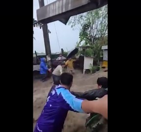 Stranded villagers rescued from floodwater surging through homes in the Philippines