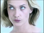 Close up of blond woman chewing bubble gum + blowing bubbles