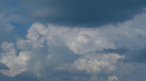 Download A plane flying in the sky with some clouds for free