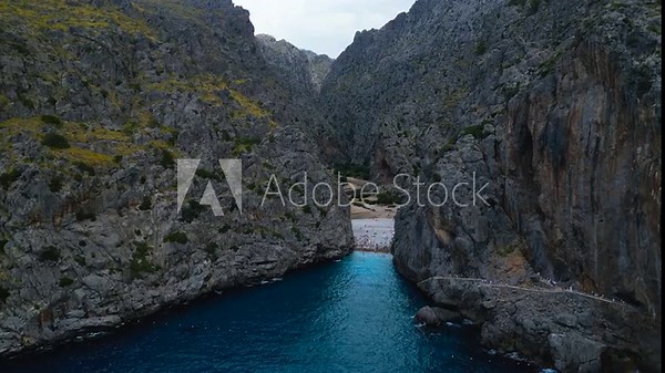 The dual beauty of Sa Calobra in Mallorca. The extreme serpentine road and the dramatic Torrent de Pareis gorge where it meets the sea, both set within the Serra de Tramuntana mountains.
